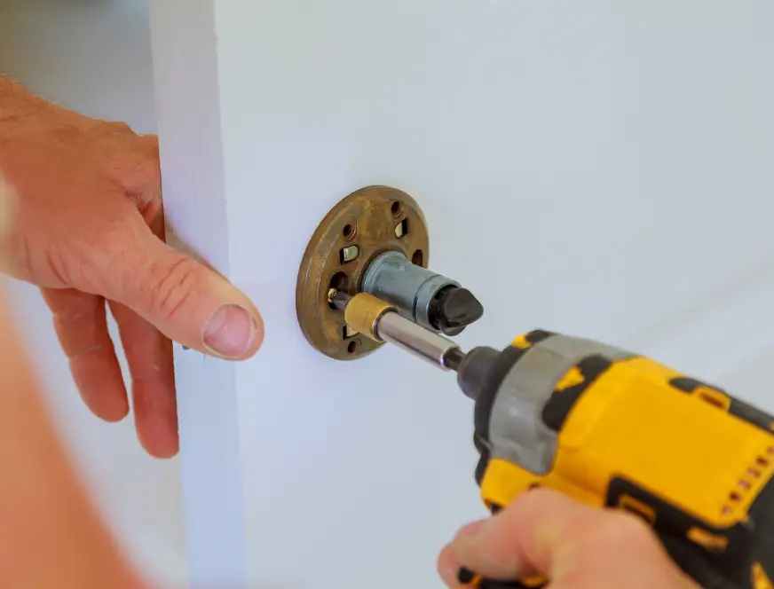 carpenter-at-lock-installation-with-electric-drill-2025-03-27-05-49-52-utc